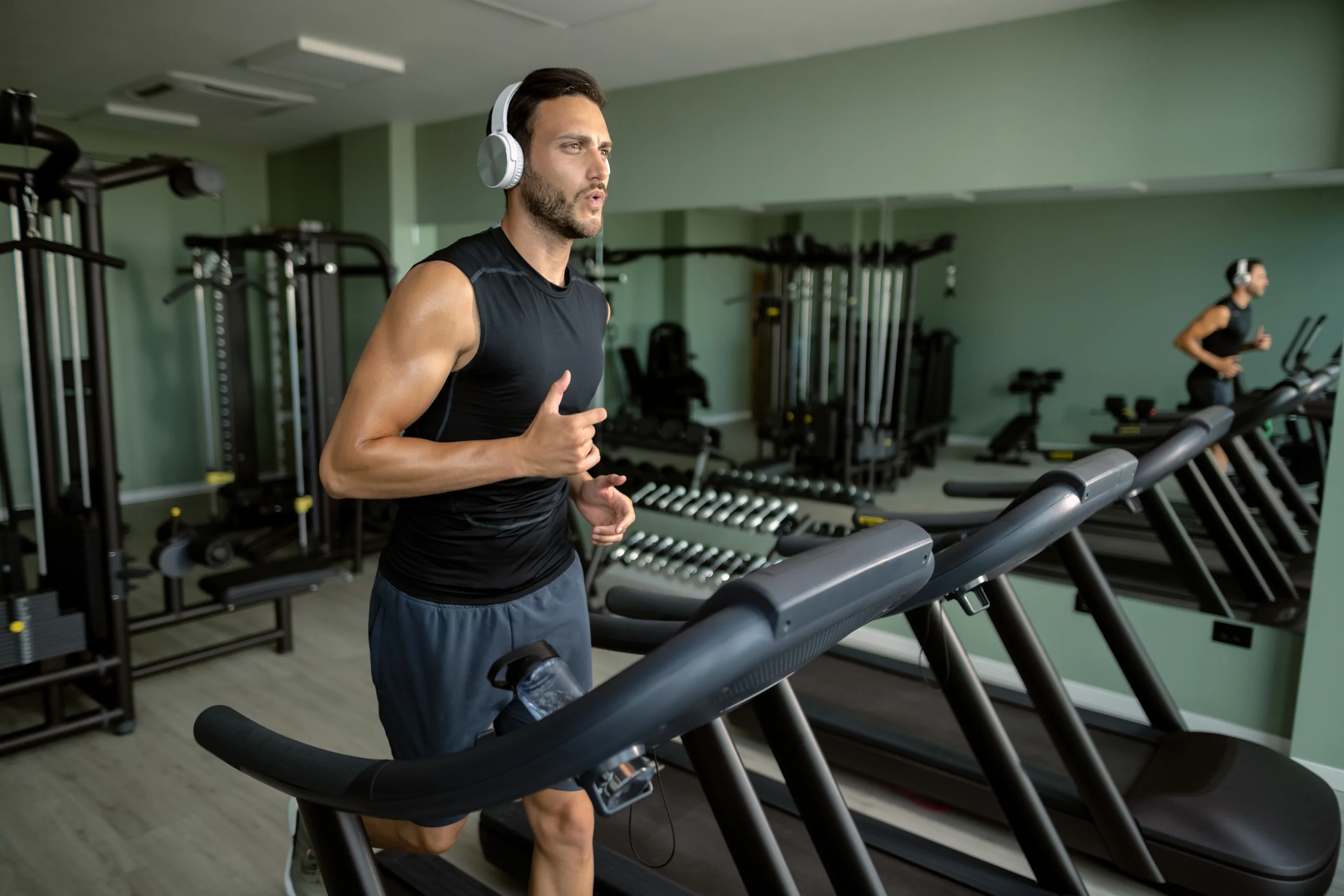 young-athletic-man-running-treadmill-gym