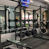 A spacious gym featuring benches, weights, and exercise machines for varied workouts.