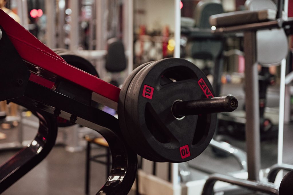 A close-up view of a loaded weightlifting machine in a modern gym setting.